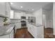 Modern kitchen with white cabinets, granite countertops, and stainless steel appliances at 181 Atwater Landing Dr, Mooresville, NC 28117