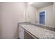 Bathroom with white cabinets, granite countertops and a large mirror at 22 Porter Nw St # Sw22, Concord, NC 28027