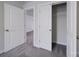 Hallway with grey carpet and several doors, including an open closet with shelving at 22 Porter Nw St # Sw22, Concord, NC 28027