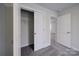 Hallway with gray carpet and two doorways, one of which leads to an open closet at 22 Porter Nw St # Sw22, Concord, NC 28027