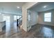 Open-concept living room with wood flooring, a staircase, and a view into the office space at 22 Porter Nw St # Sw22, Concord, NC 28027