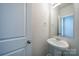 Neat powder room with a pedestal sink, a framed mirror, and white paint at 22 Porter Nw St # Sw22, Concord, NC 28027