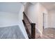 Carpeted staircase with modern black banister in open living area at 22 Porter Nw St # Sw22, Concord, NC 28027