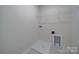 A simple laundry room with tile floors and connections for a washer and dryer at 22 Porter Nw St # Sw22, Concord, NC 28027