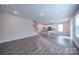 Open-concept living area with a staircase, a kitchen, and bright lighting at 22 Porter Nw St # Sw22, Concord, NC 28027