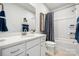 Contemporary bathroom with a vanity, toilet, and shower/tub combo with stylish blue patterned curtain at 888 Exeter Dr, Sherrills Ford, NC 28673