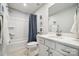 Bright bathroom with white vanity, a shower/tub with a curtain, and modern fixtures at 888 Exeter Dr, Sherrills Ford, NC 28673