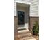 Inviting front door entrance with brick columns and a charming wreath at 546 Amalfi Dr, Davidson, NC 28036