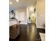 Hallway with dark hardwood floors and a nautical-themed wall decor at 546 Amalfi Dr, Davidson, NC 28036