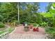 Landscaped backyard featuring a fire pit and seating at 4364 Hager Mountain Ln, Iron Station, NC 28080