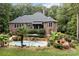 Stunning backyard features a brick home, pool, and beautiful landscaping for ultimate outdoor relaxation at 4364 Hager Mountain Ln, Iron Station, NC 28080