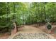 Long driveway leading to home through lush trees at 4364 Hager Mountain Ln, Iron Station, NC 28080