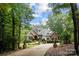 Brick house with stone accents, nestled in trees at 4364 Hager Mountain Ln, Iron Station, NC 28080