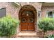 Inviting double wood front doors with stone accents and wreaths at 4364 Hager Mountain Ln, Iron Station, NC 28080