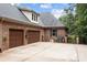 Two-car garage with brick exterior and ample driveway space at 4364 Hager Mountain Ln, Iron Station, NC 28080