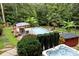 Inviting pool and hot tub area, surrounded by lush landscaping at 4364 Hager Mountain Ln, Iron Station, NC 28080