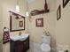 Stylish powder room with dark vanity and updated fixtures at 4364 Hager Mountain Ln, Iron Station, NC 28080