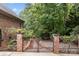 Brick pillars and wrought iron gate open to a path at 4364 Hager Mountain Ln, Iron Station, NC 28080