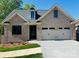 Charming brick home featuring a two-car garage and freshly landscaped front yard at 5106 Silver Trace Ln # 90, Denver, NC 28037