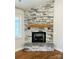 Detailed view of the living room fireplace with a stone surround and decorative mantel at 5106 Silver Trace Ln # 90, Denver, NC 28037