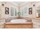 Elegant bathroom with soaking tub, double vanities, and large windows at 7025 Willow Trace Ln, Weddington, NC 28104