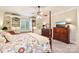 Bright bedroom featuring a large bed, built-in shelving, and a dresser at 7025 Willow Trace Ln, Weddington, NC 28104