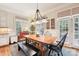 Kitchen dining area with wood table and French doors at 7025 Willow Trace Ln, Weddington, NC 28104