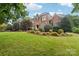 Brick home with manicured lawn and landscaping at 7025 Willow Trace Ln, Weddington, NC 28104