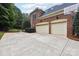 Two-car garage with a spacious driveway and basketball court at 7025 Willow Trace Ln, Weddington, NC 28104