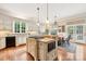 Island kitchen with granite counters and white cabinets at 7025 Willow Trace Ln, Weddington, NC 28104