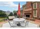 Relaxing patio with seating area and outdoor fireplace at 7025 Willow Trace Ln, Weddington, NC 28104