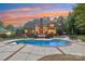 Freeform swimming pool with a large patio area at 7025 Willow Trace Ln, Weddington, NC 28104