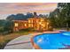 Inviting pool and patio area at sunset at 7025 Willow Trace Ln, Weddington, NC 28104