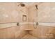 Spa-like shower with herringbone tile and built-in seat at 7025 Willow Trace Ln, Weddington, NC 28104