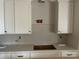 White shaker cabinets, quartz countertops, and neutral backsplash at 90 Silver Trace Ln # 90, Denver, NC 28037