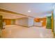 Expansive basement area featuring tile flooring, a staircase with green trim, and ample storage space at 1405 Northcrest Dr, Albemarle, NC 28001