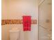 Clean bathroom featuring a standard toilet with decorative wall trim and a glass-enclosed shower at 1405 Northcrest Dr, Albemarle, NC 28001