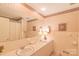 Bathroom featuring double sinks, a framed mirror and a shower with a curtain at 1405 Northcrest Dr, Albemarle, NC 28001