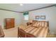 Bright bedroom boasts carpeted floors, decorative trim and a window for ample natural light at 1405 Northcrest Dr, Albemarle, NC 28001