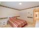 Well-lit bedroom with striped bedspread, white headboard, and a closet with shuttered doors at 1405 Northcrest Dr, Albemarle, NC 28001