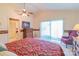 Cozy bedroom features a ceiling fan, dresser, and sliding glass doors to bring in natural light at 1405 Northcrest Dr, Albemarle, NC 28001