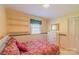 Comfortable bedroom with built-in shelves, a dresser and a large window at 1405 Northcrest Dr, Albemarle, NC 28001