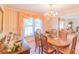 Charming dining room with chandelier, wood table, and elegant striped wallpaper at 1405 Northcrest Dr, Albemarle, NC 28001