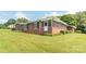 Charming brick home with a screened porch, lush lawn, and mature landscaping at 1405 Northcrest Dr, Albemarle, NC 28001