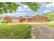 Charming brick ranch-style home with an attached two-car garage and a well-maintained lawn at 1405 Northcrest Dr, Albemarle, NC 28001