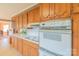 Bright kitchen showcases wood cabinets, white appliances, and a built-in oven at 1405 Northcrest Dr, Albemarle, NC 28001
