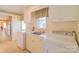 Well-lit laundry room features washer, dryer, sink, and cabinetry for storage at 1405 Northcrest Dr, Albemarle, NC 28001