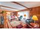 Spacious living room with hardwood floors, brick fireplace, and comfortable seating arrangements at 1405 Northcrest Dr, Albemarle, NC 28001
