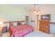 Spacious main bedroom with floral bedding, ceiling fan, and closet access at 1405 Northcrest Dr, Albemarle, NC 28001