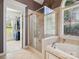 Bathroom includes a walk-in shower, soaking tub, and a large window at 418 Sebring Ct, Belmont, NC 28012